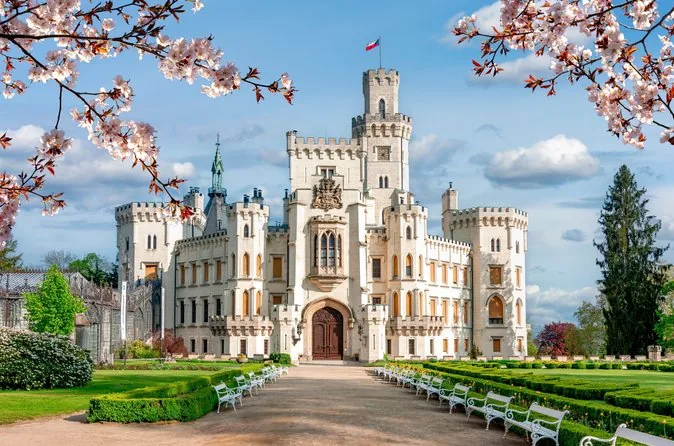 The white neo-Gothic Hluboká Castle behind formal gardens