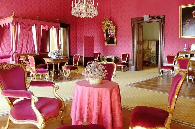 A red silk salon with gilded furniture inside Český Krumlov Castle