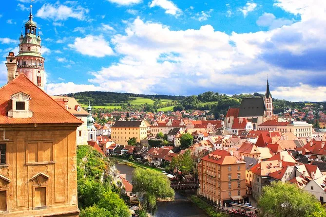 The castle tower and old town roofs of Český Krumlov under a blue sky